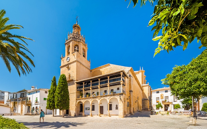 Church Santa Maria La Mayor in Ronda, Andalusia, with bell tower and courtyard.