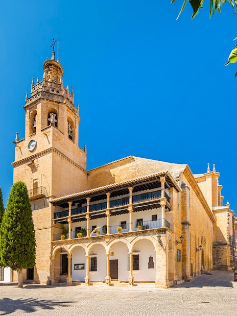 Church Santa Maria La Mayor in Ronda, Andalusia, with bell tower and courtyard.