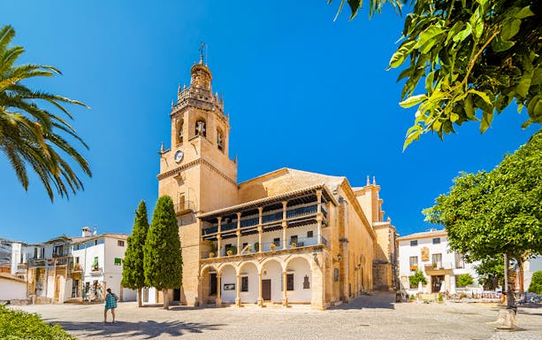 Church Santa Maria La Mayor in Ronda, Andalusia, with bell tower and courtyard.