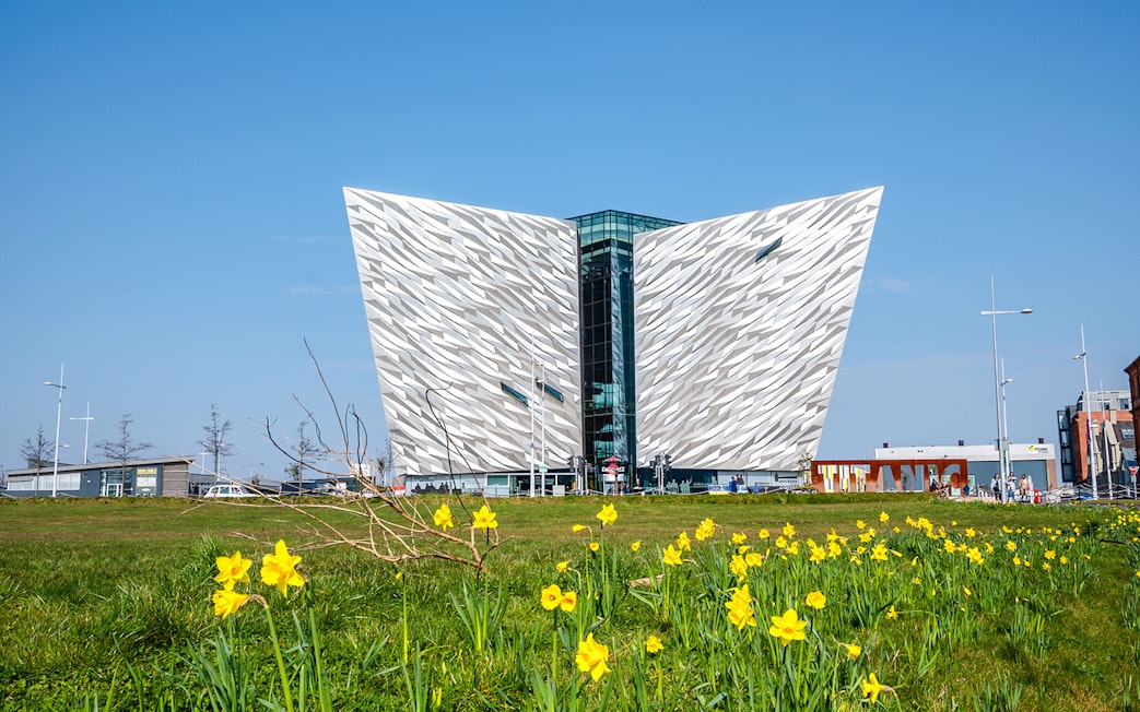 Titanic Museum facade with daffodils in Belfast, Northern Ireland.