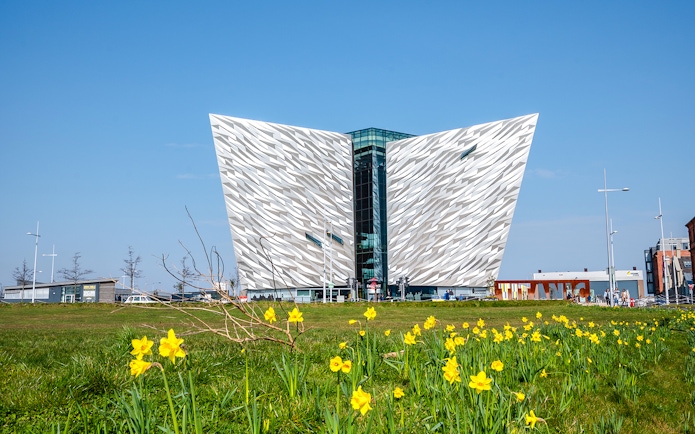 Titanic Museum facade with daffodils in Belfast, Northern Ireland.