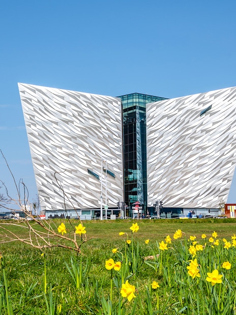 Titanic Museum facade with daffodils in Belfast, Northern Ireland.