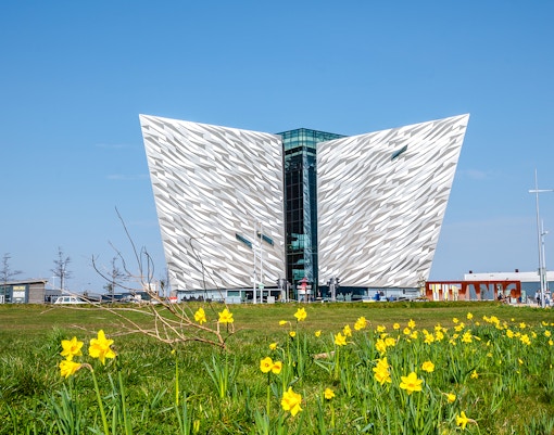 Titanic Museum facade with daffodils in Belfast, Northern Ireland.