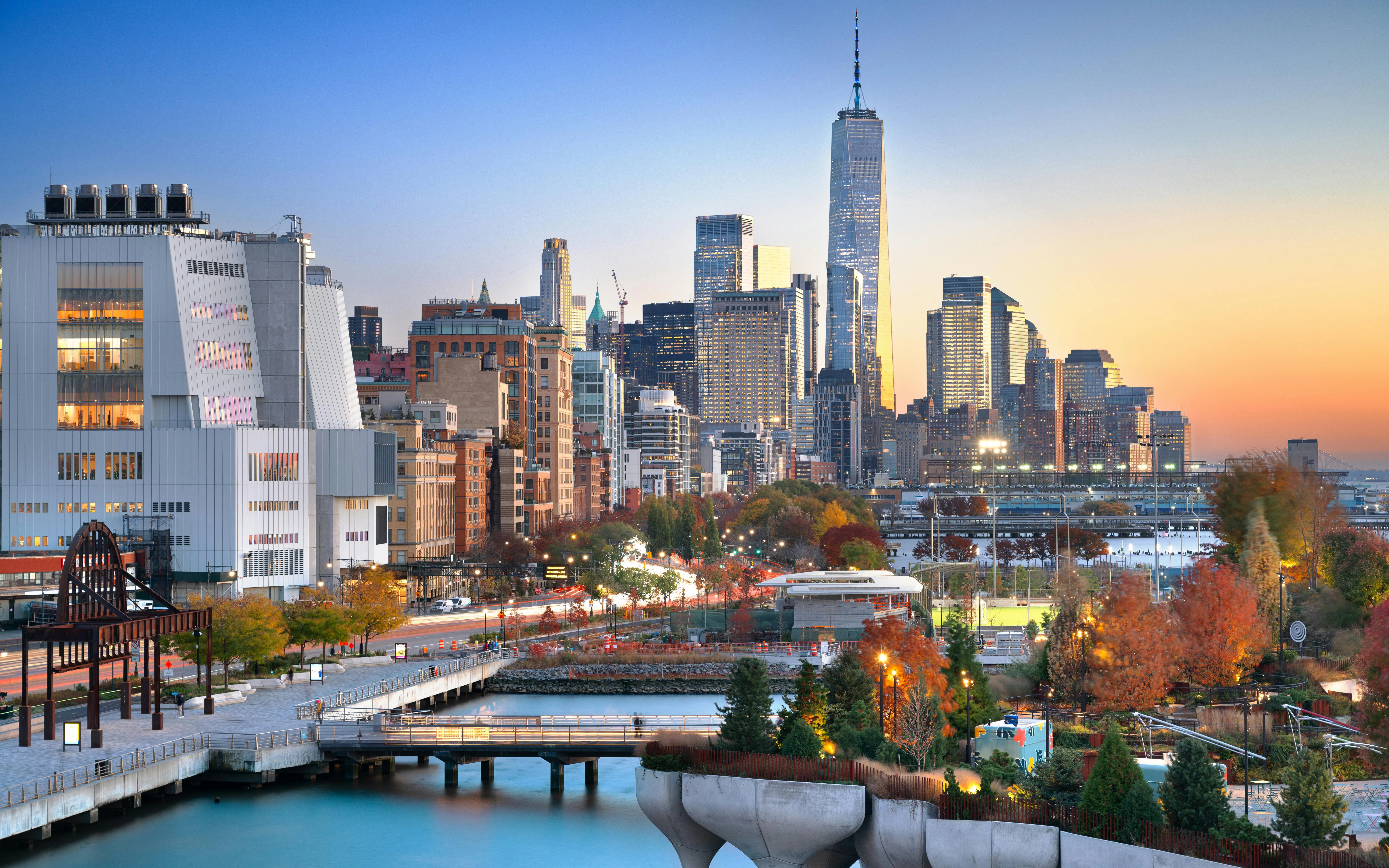 Lower Manhattan skyline at dusk with autumn foliage, view from Chelsea.