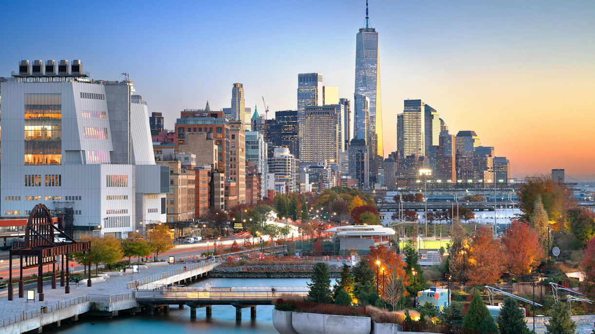 Lower Manhattan skyline at dusk with autumn foliage, view from Chelsea.