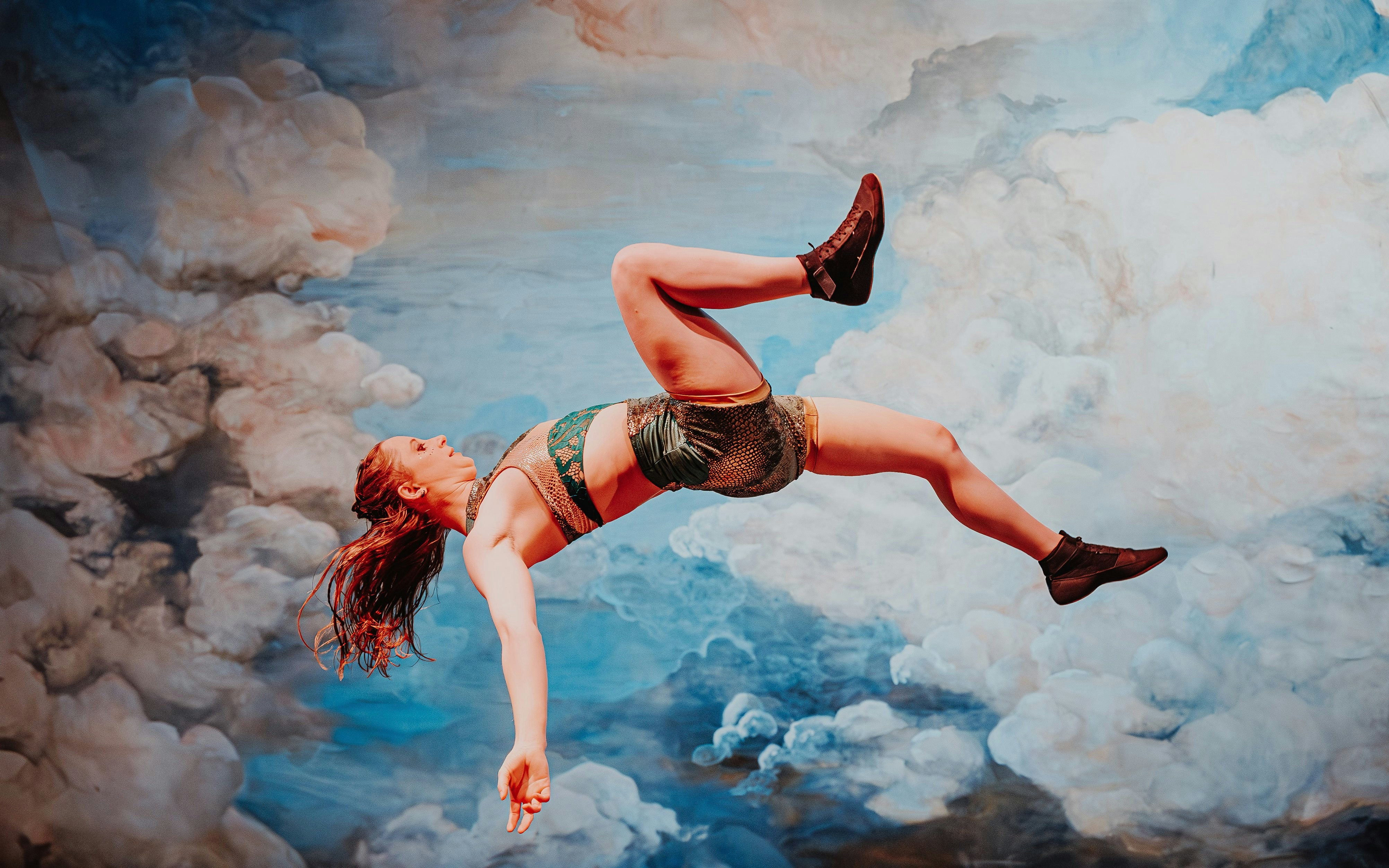 Performer mid-air during Come Alive Westend stage show.