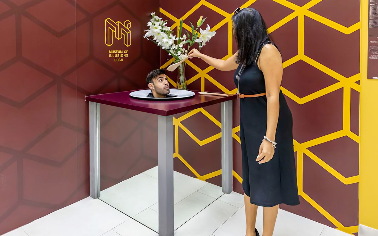 Couple viewing Head on a Platter exhibit at Museum of Illusions, Dubai.