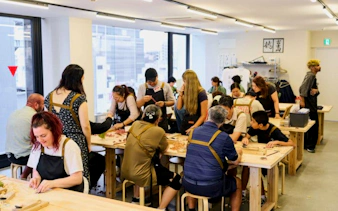 Participants engaging in a Kintsugi workshop in Shinjuku, Tokyo, repairing pottery with gold.