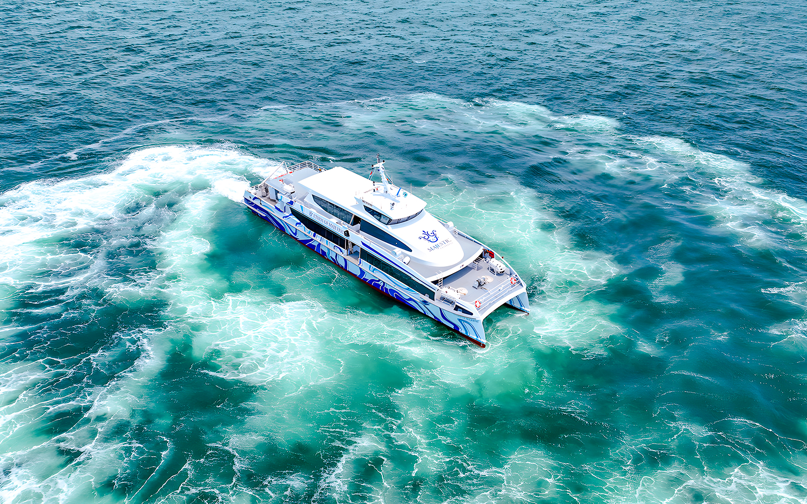 Ferry cruising from Singapore to Batam on clear blue waters.