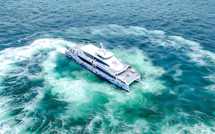 Ferry cruising from Singapore to Batam on clear blue waters.