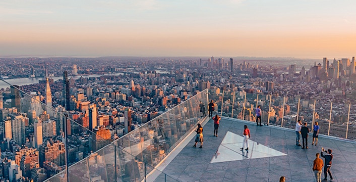 Visitors enjoying the view from Edge NYC observation deck at sunset.
