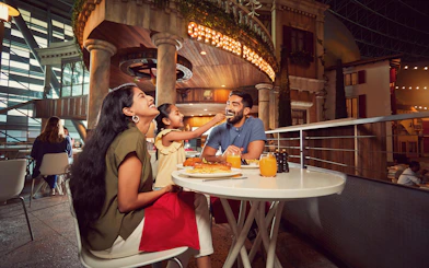 Family dining at Ferrari World Abu Dhabi with themed restaurant backdrop.