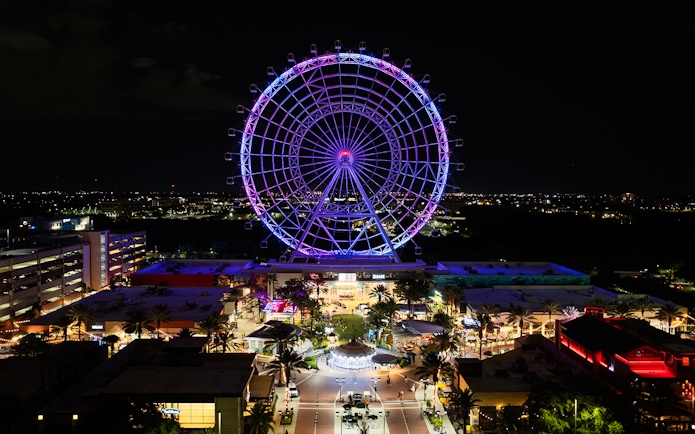 Ferris wheel illuminated at night in ICON Park, Orlando.