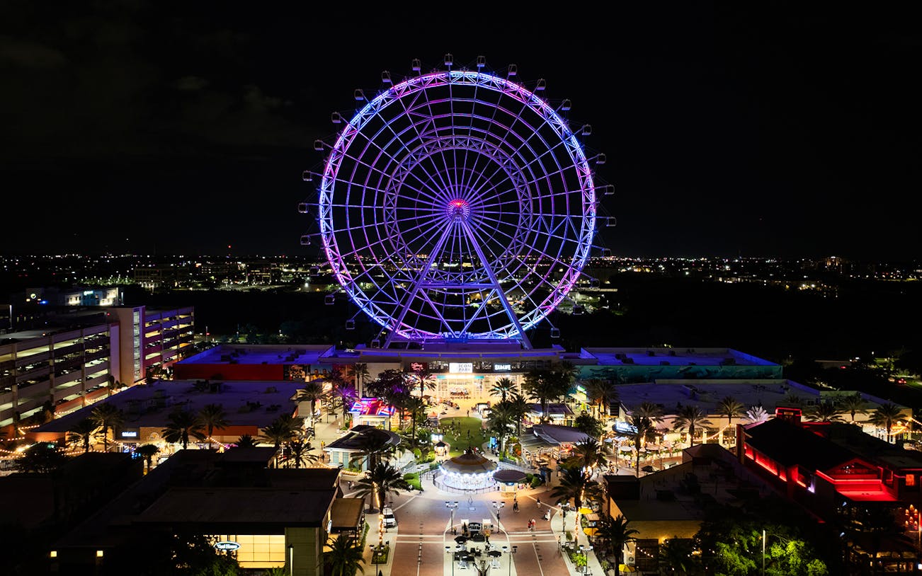 Ferris wheel illuminated at night in ICON Park, Orlando.