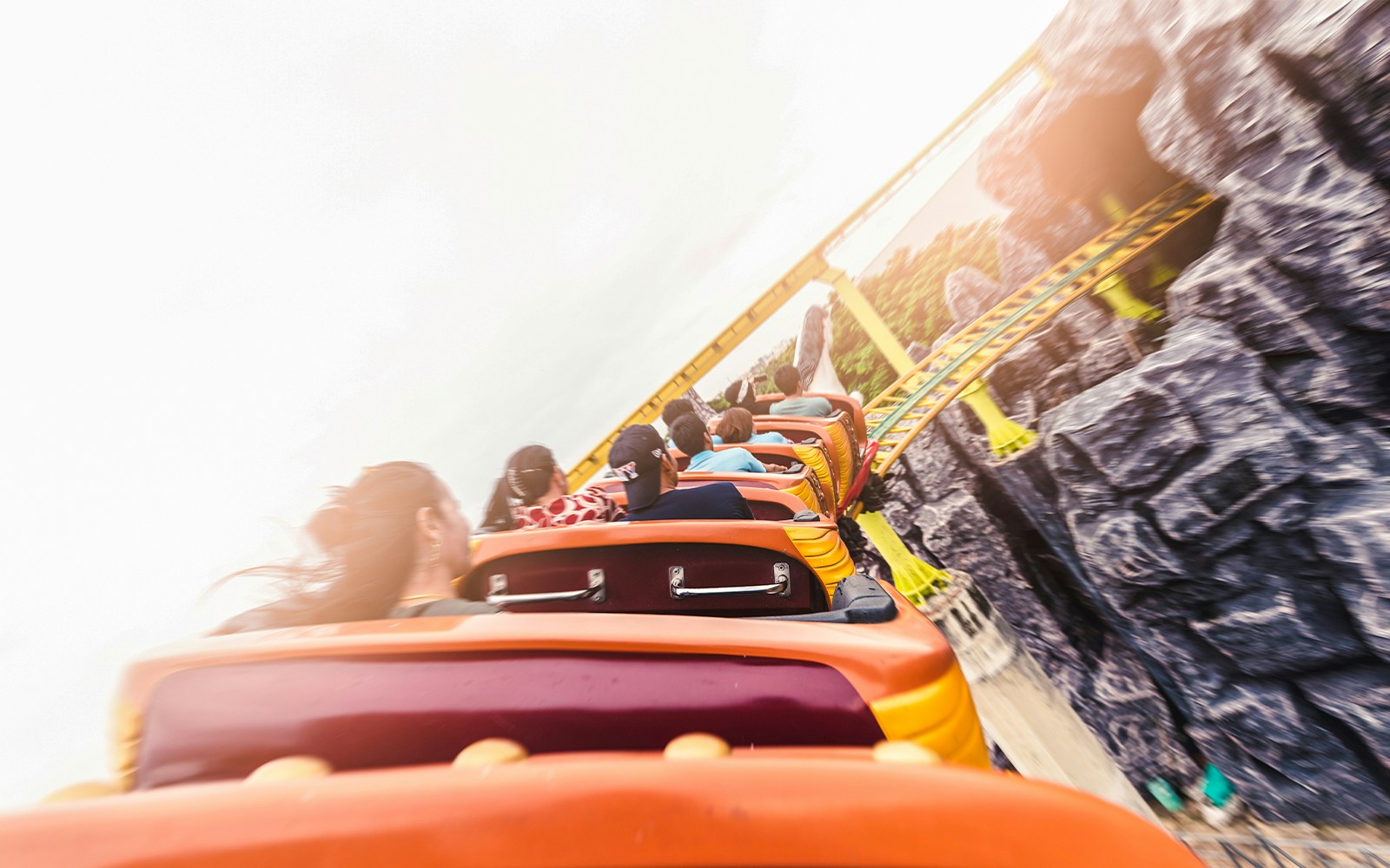 Roller coaster on track at amusement park, showcasing thrilling ride experience.