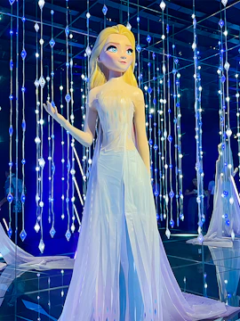 Frozen character statue at Disney100 Village with illuminated backdrop.