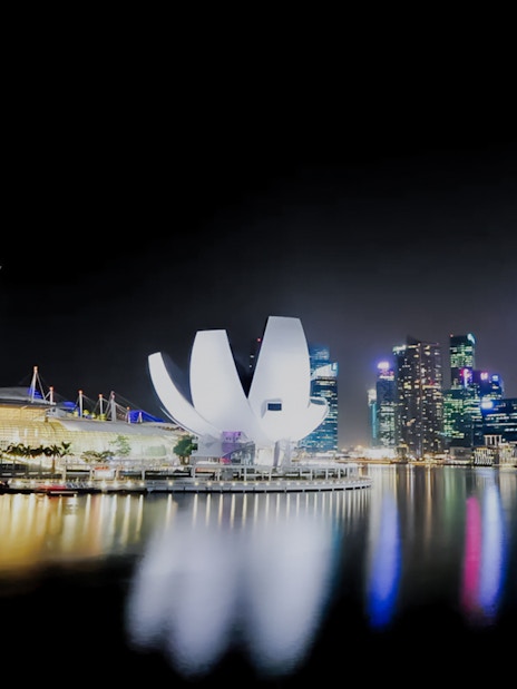 Marina Bay Sands and skyline at night during yacht cruise in Singapore.