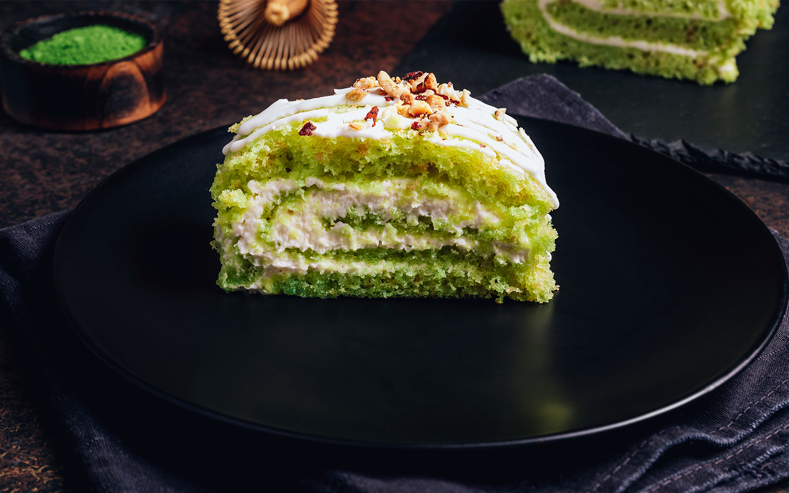 Matcha filled cream bun on a black plate