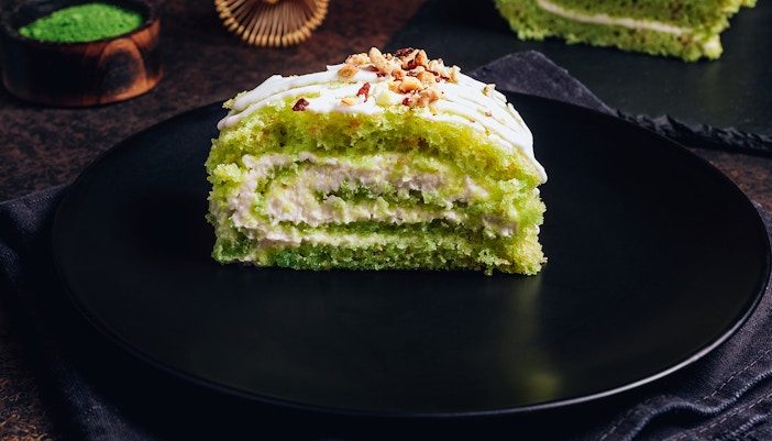 Matcha filled cream bun on a black plate