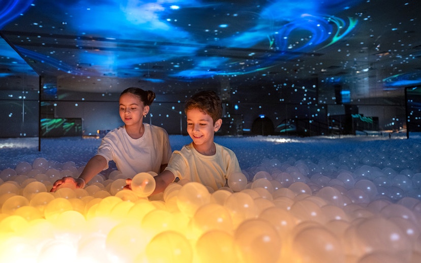 Children playing with glowing balls at Celestia inside AYA Universe.