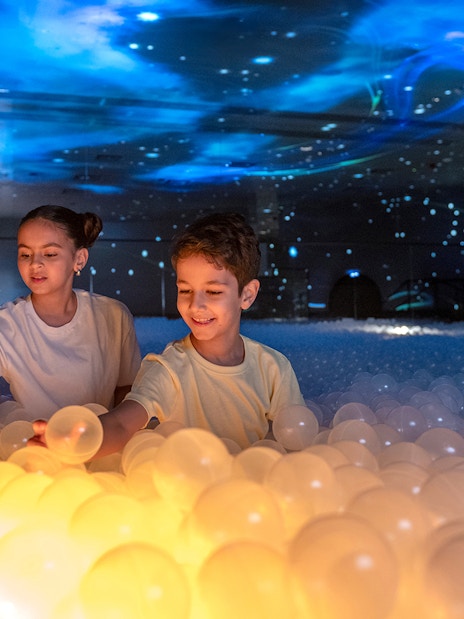 Children playing with glowing balls at Celestia inside AYA Universe.