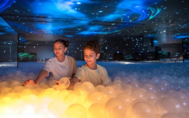 Children playing with glowing balls at Celestia inside AYA Universe.