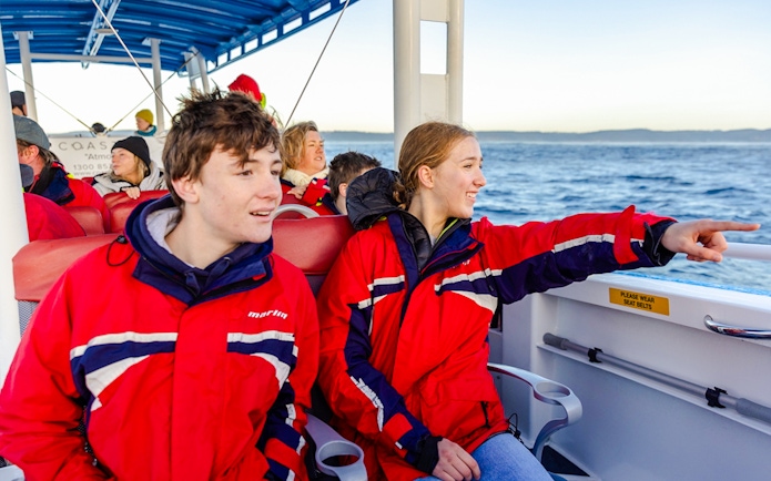 People on a boat whale watching in Newcastle, Australia.
