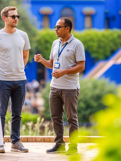 Guide explaining to visitors in Jardin Majorelle, Marrakech.