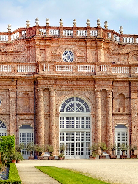Savoy Royal Residence facade at La Venaria Reale, Turin, with manicured gardens.