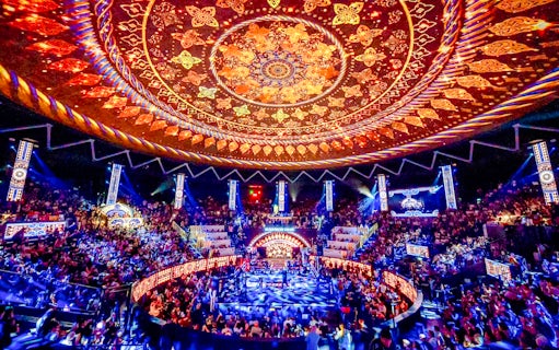 Rajadamnern Boxing Stadium interior with ornate ceiling and vibrant crowd.
