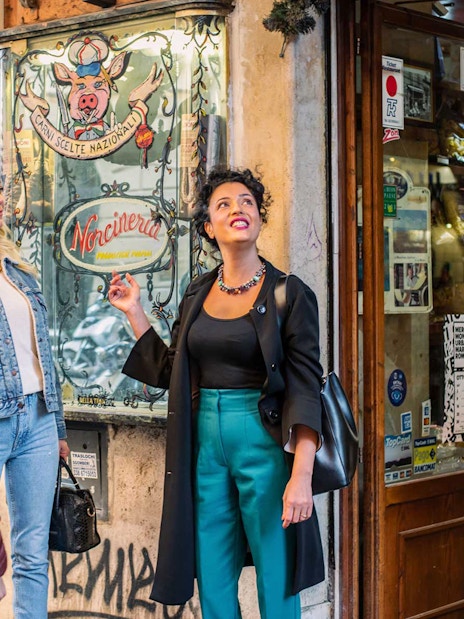 Tour group exploring a deli in Trastevere during a guided food and wine tour.