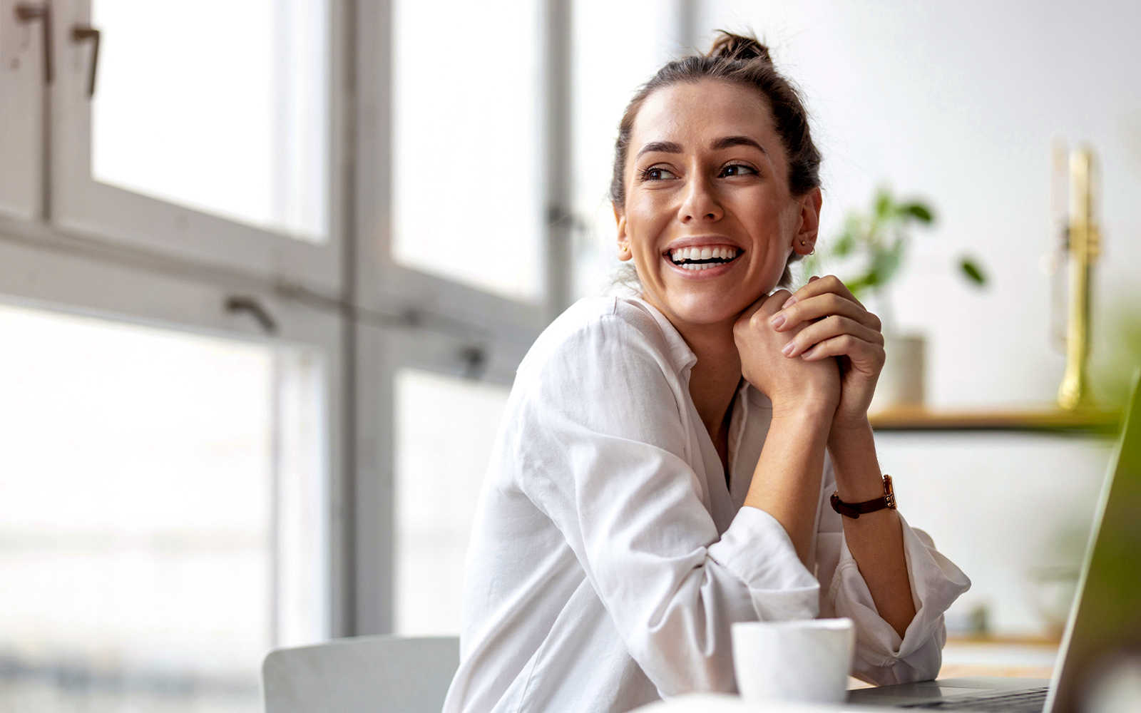 smiling woman observing her children from observation zone at kidzania dubai