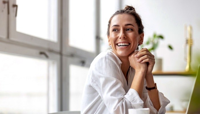 smiling woman observing her children from observation zone at kidzania dubai