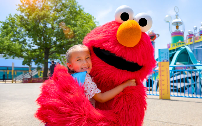 Child hugging Elmo at Sesame Place Philadelphia.
