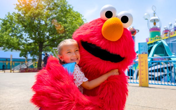 Child hugging Elmo at Sesame Place Philadelphia.