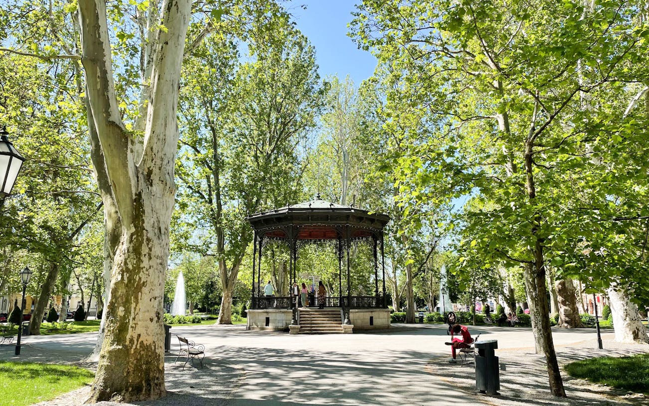 Gazebo in Zagreb park surrounded by trees, part of small group guided tour.