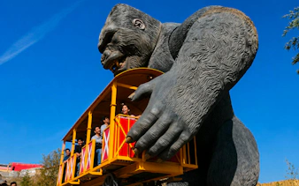 Guests on a ride held by a giant gorilla statue at Vialand Theme Park, Istanbul.