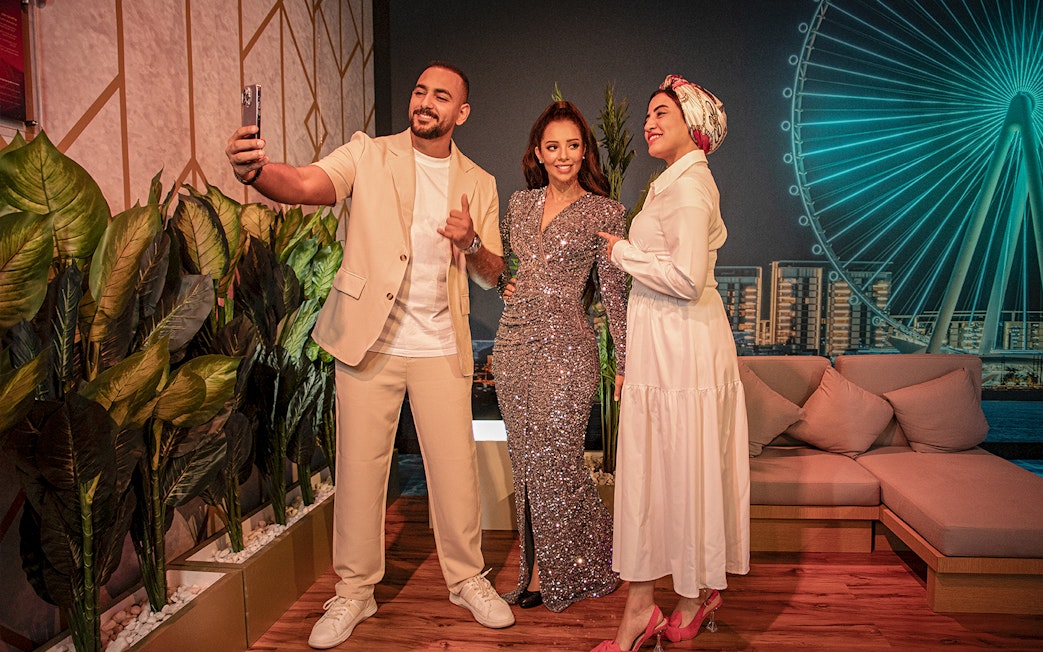 Balqees Fathi wax figure with visitors at Madame Tussauds Dubai, near Dubai Eye.