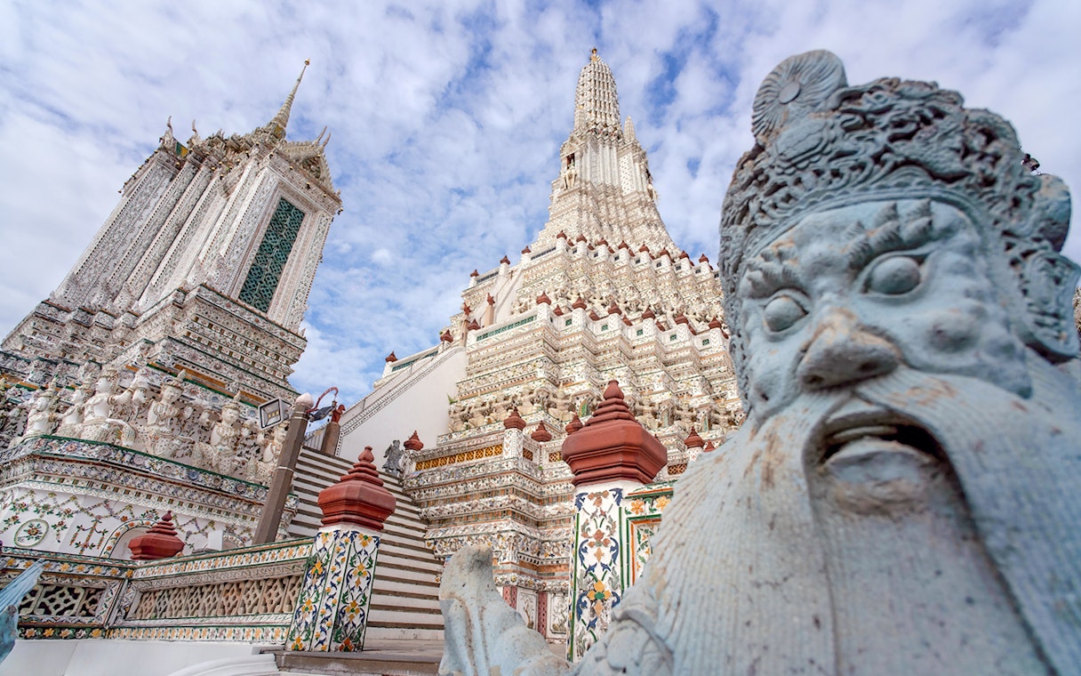 Wat Arun temple with intricate details and statue, Bangkok Night Tour.