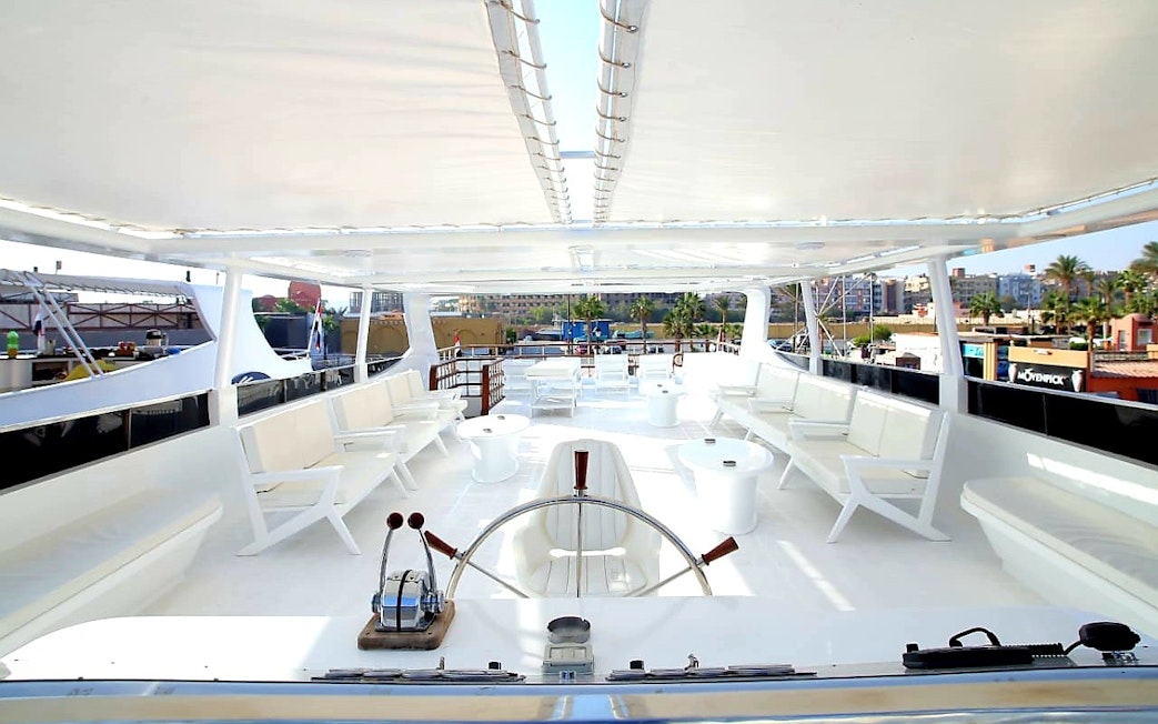 Upper deck of a luxury boat with seating, part of a Red Sea excursion in Hurghada.