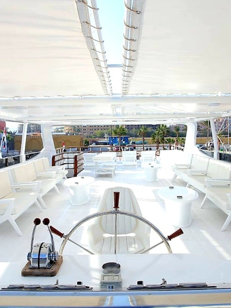 Upper deck of a luxury boat with seating, part of a Red Sea excursion in Hurghada.