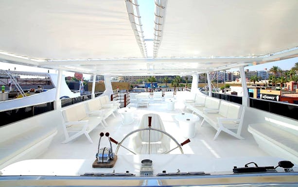 Upper deck of a luxury boat with seating, part of a Red Sea excursion in Hurghada.