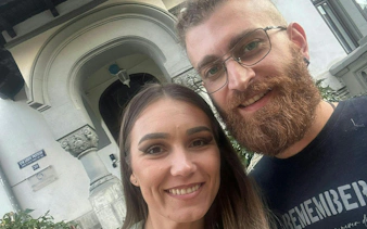 Couple in front of historic Cotroceni building, Bucharest, during self-guided city exploration game.