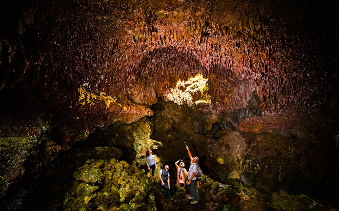 Guests exploring inside Hualalai Volcano on the Hidden Craters Hike.