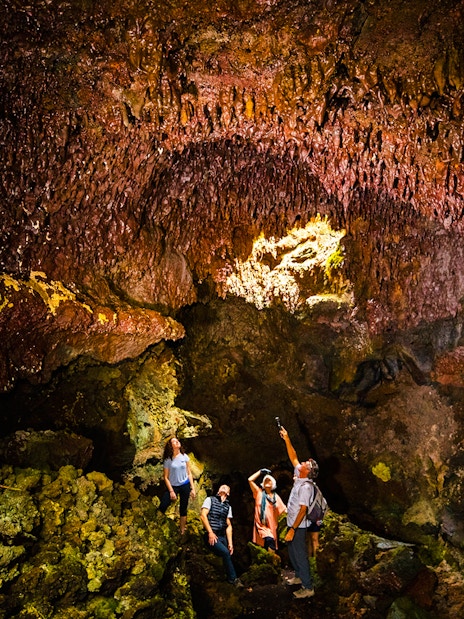 Guests exploring inside Hualalai Volcano on the Hidden Craters Hike.
