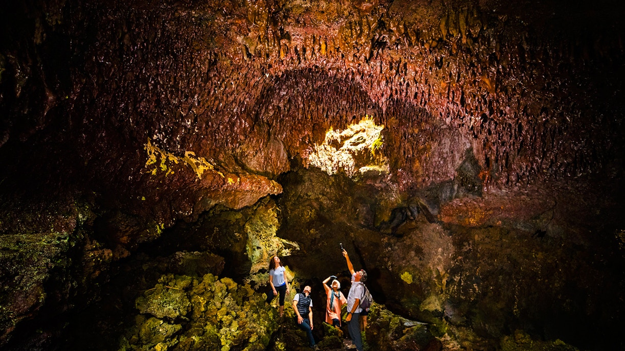 Guests exploring inside Hualalai Volcano on the Hidden Craters Hike.