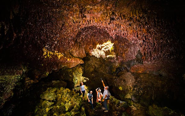 Guests exploring inside Hualalai Volcano on the Hidden Craters Hike.