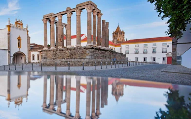 Roman Temple of Évora with surrounding historic buildings in Évora, Portugal.