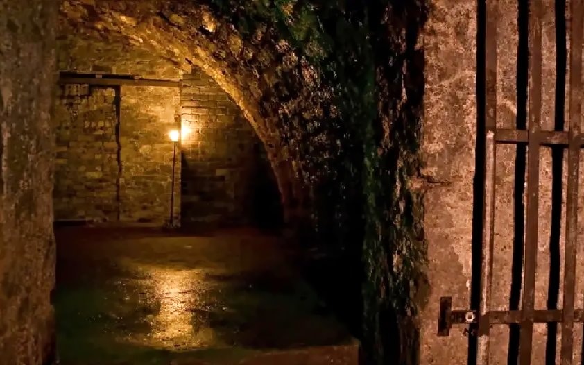 Edinburgh haunted vaults with dim lighting and stone walls.