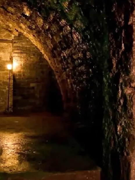 Edinburgh haunted vaults with dim lighting and stone walls.
